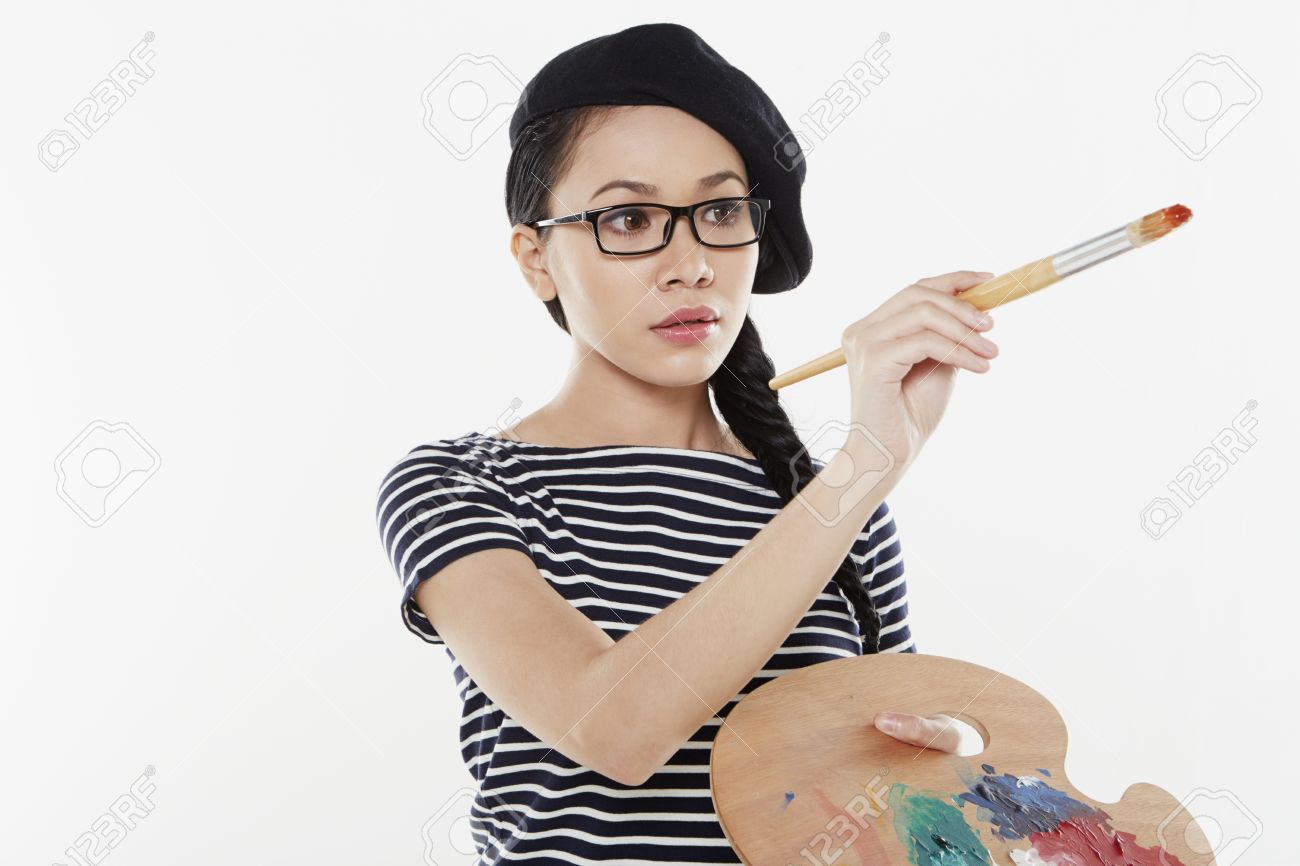 22654155-female-artist-holding-a-paint-brush-and-palette.jpg