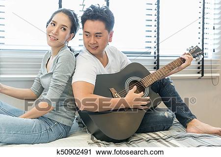 young-couples-playing-guitar-stock-photography__k50902491.jpg
